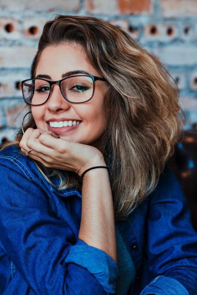 Smiling woman wearing eyeglasses at dental office