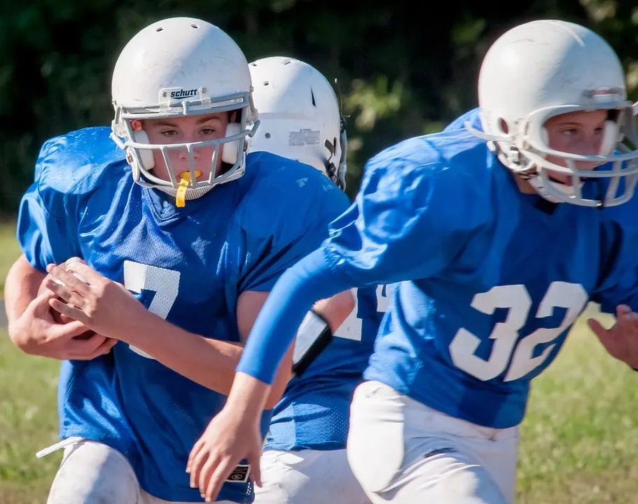 Youth football players wearing protective gear
