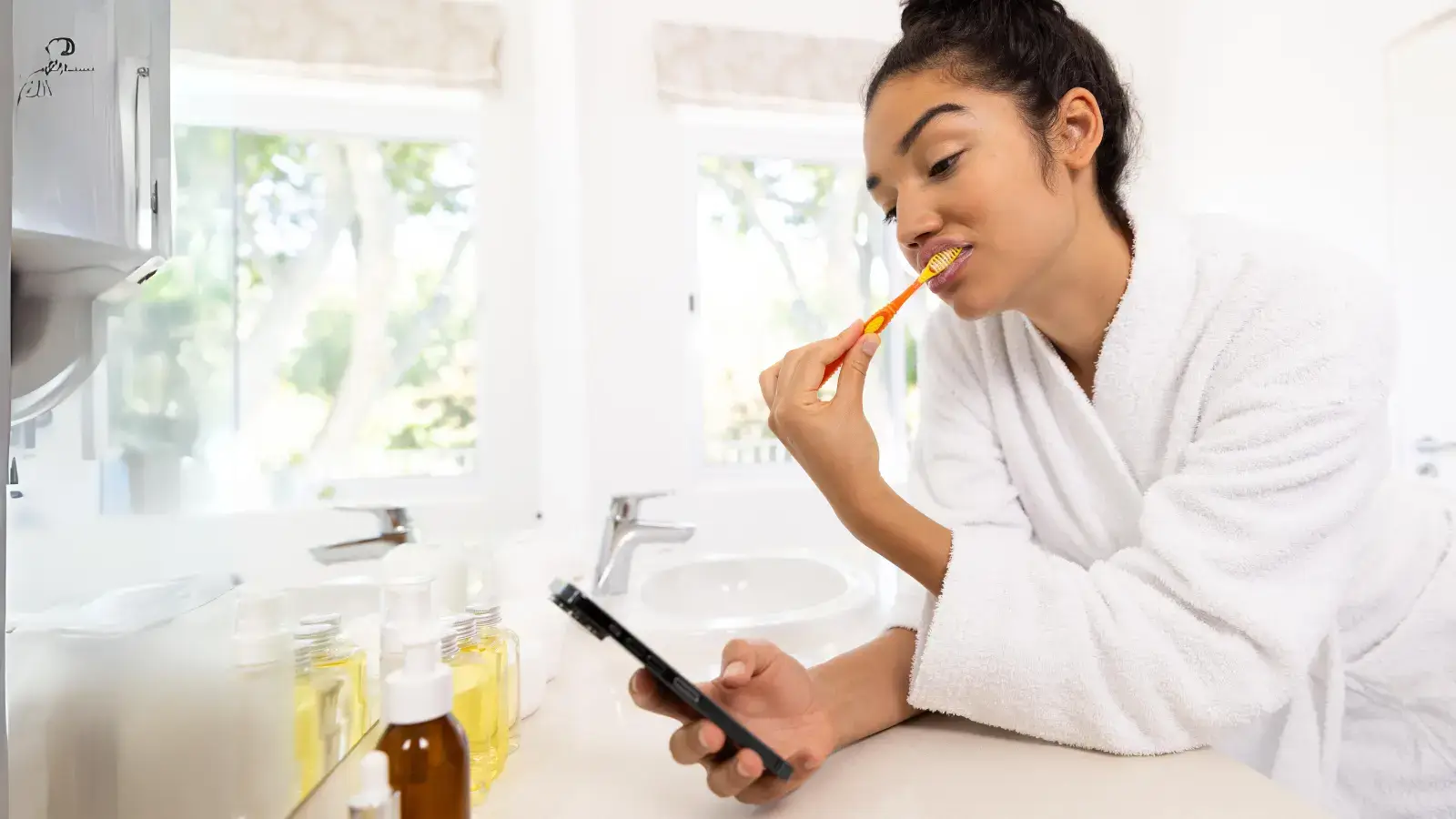 Woman brushing teeth while using mobile