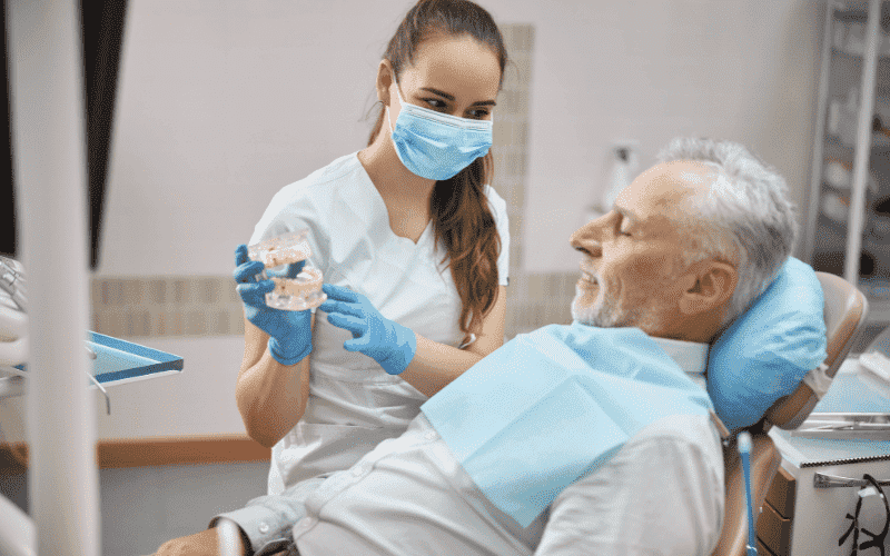 Dentist discussing oral health with senior patient