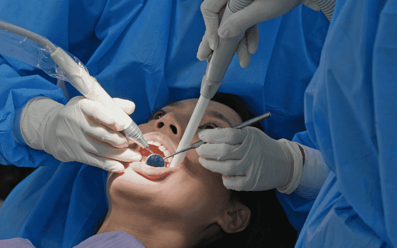 Oral surgery procedure performed by dental team