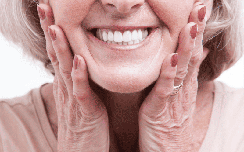 Patient smiling with dentures and restored smile